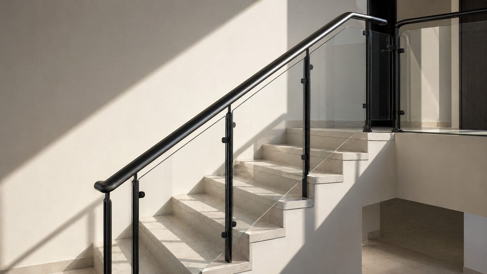 Qobban stair and terrace railing in black steel against pale stone