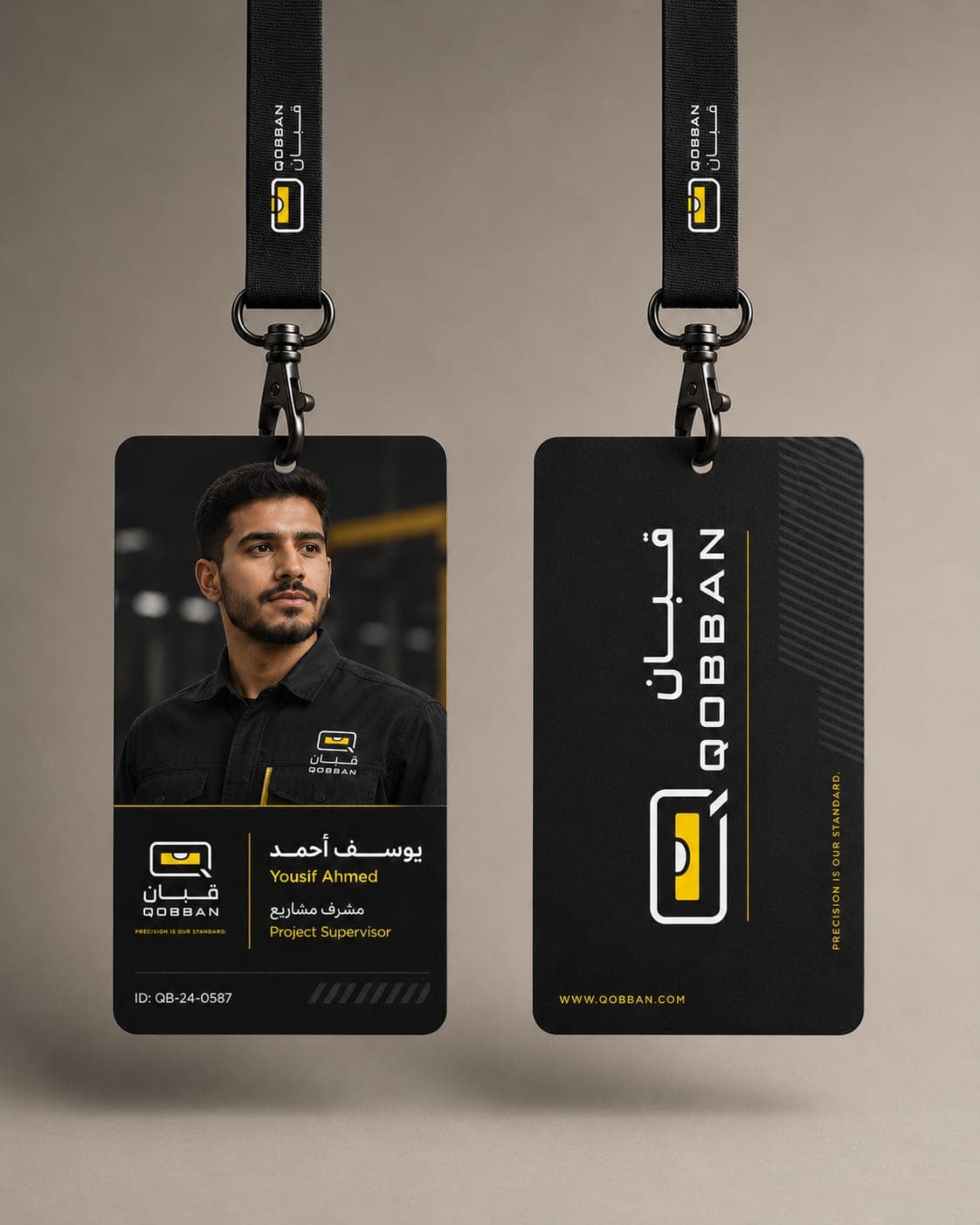 Qobban staff ID cards on black lanyards, front and back — a project supervisor's photo card and the reverse carrying the mark